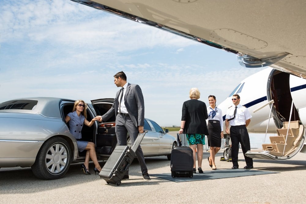 Woman getting out of car to board a private plane